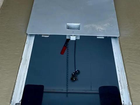 In-ground FlatSafe garage shelter lid open in garage floor