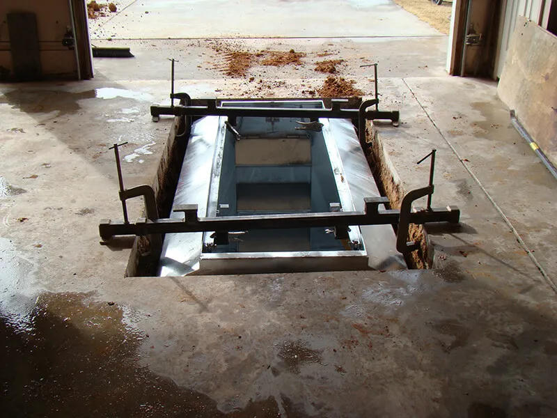 In-ground shelter being installed in garage slab