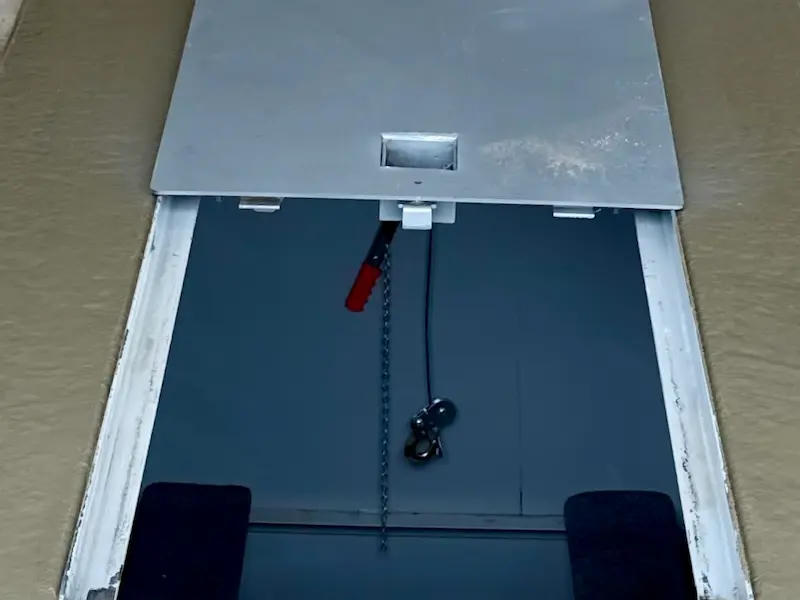 In-ground FlatSafe garage shelter lid open in garage floor